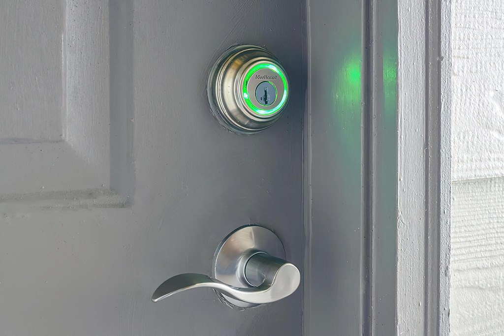 a stainless steel door handle with a green light on it