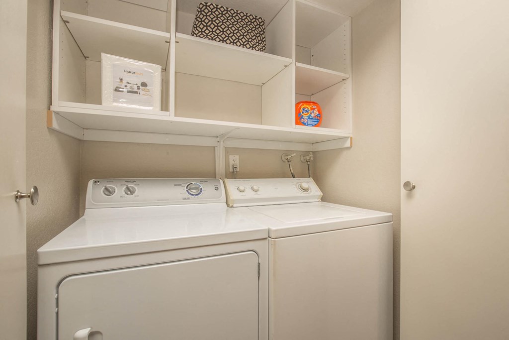 a white laundry room with a washer and dryer