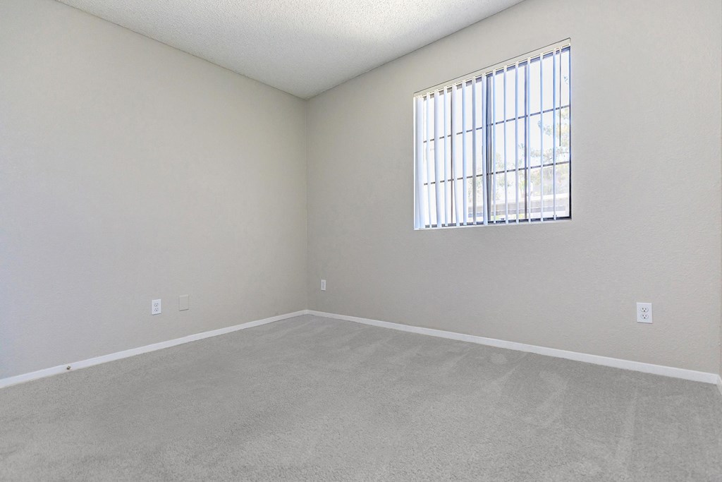 an empty living room with a large window