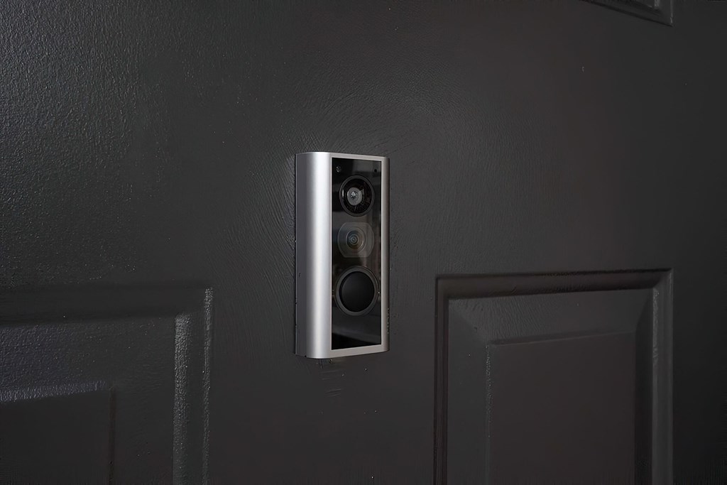 a surround sound speaker on the wall next to a door