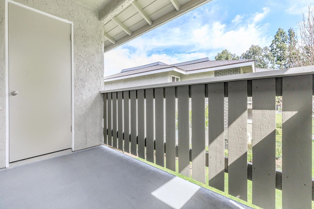 the balcony has a door to the yard and a view of the house