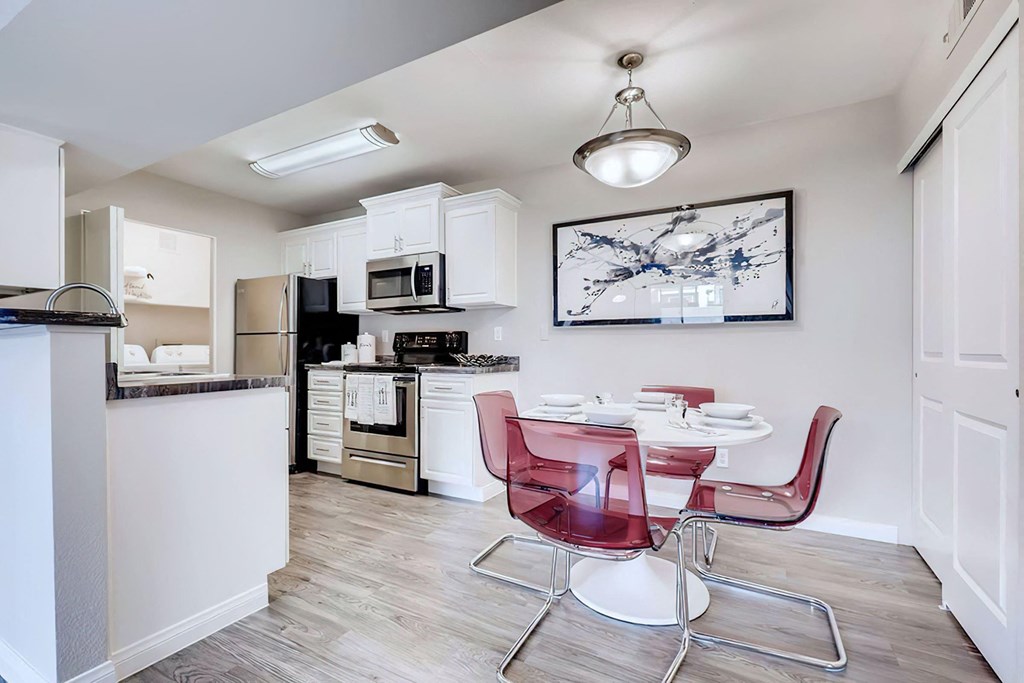 a kitchen and dining area with a table and chairs