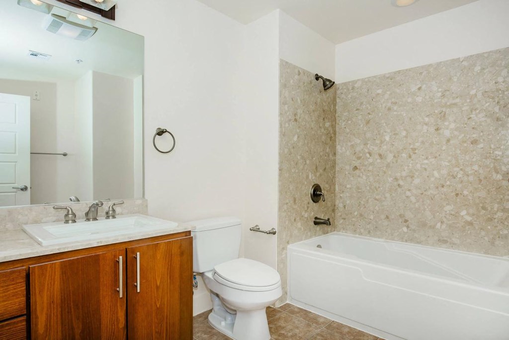 a bathroom with a sink toilet and a bath tub