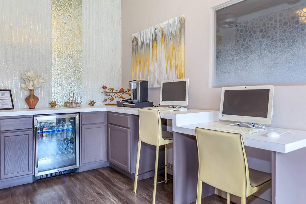 a home office with two desks and two computer monitors