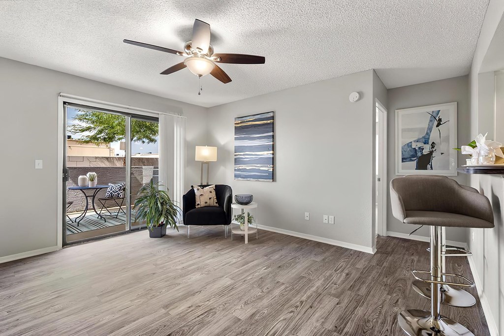 a living room with a ceiling fan and a window