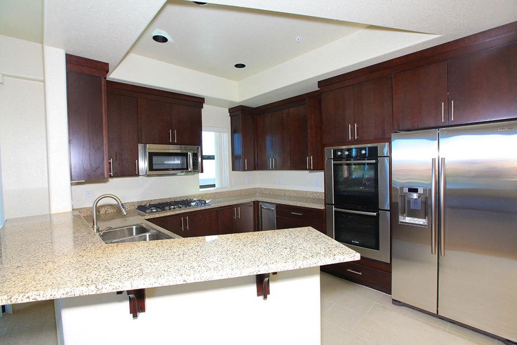 a kitchen with granite counter tops and stainless steel appliances