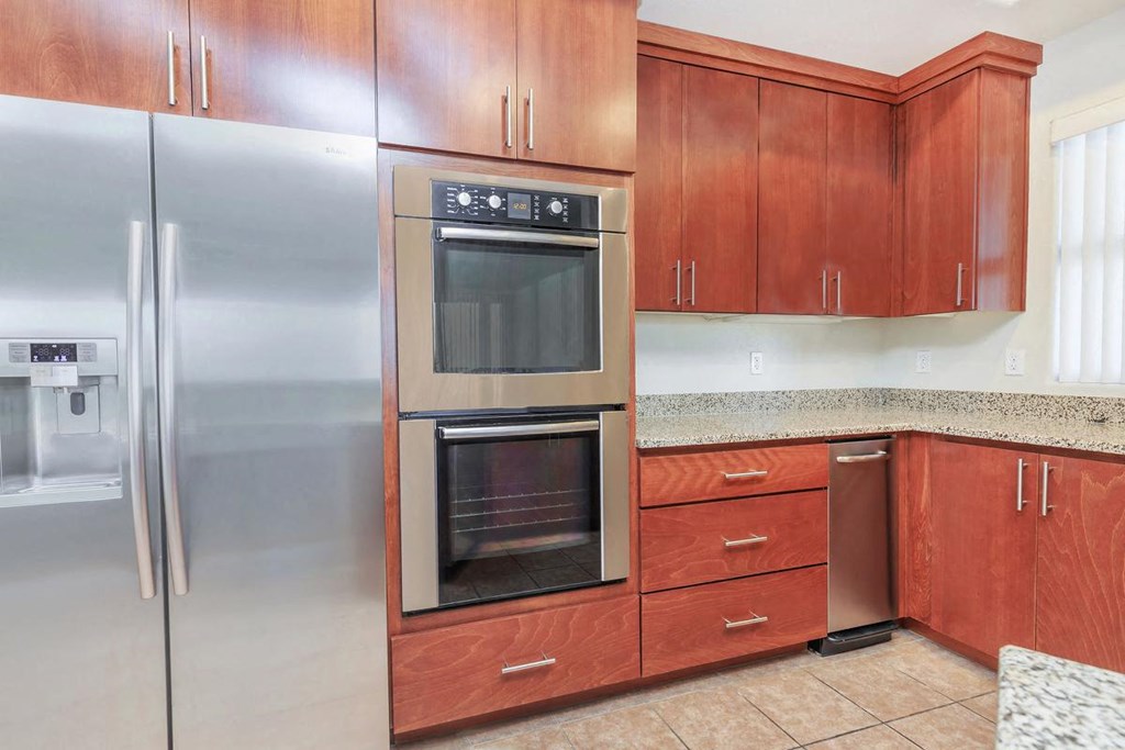 a kitchen with stainless steel appliances and wooden cabinets