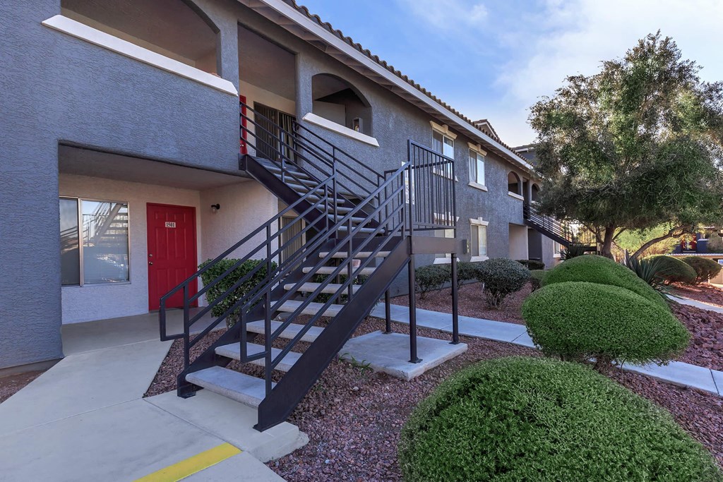 a building with stairs and a red door