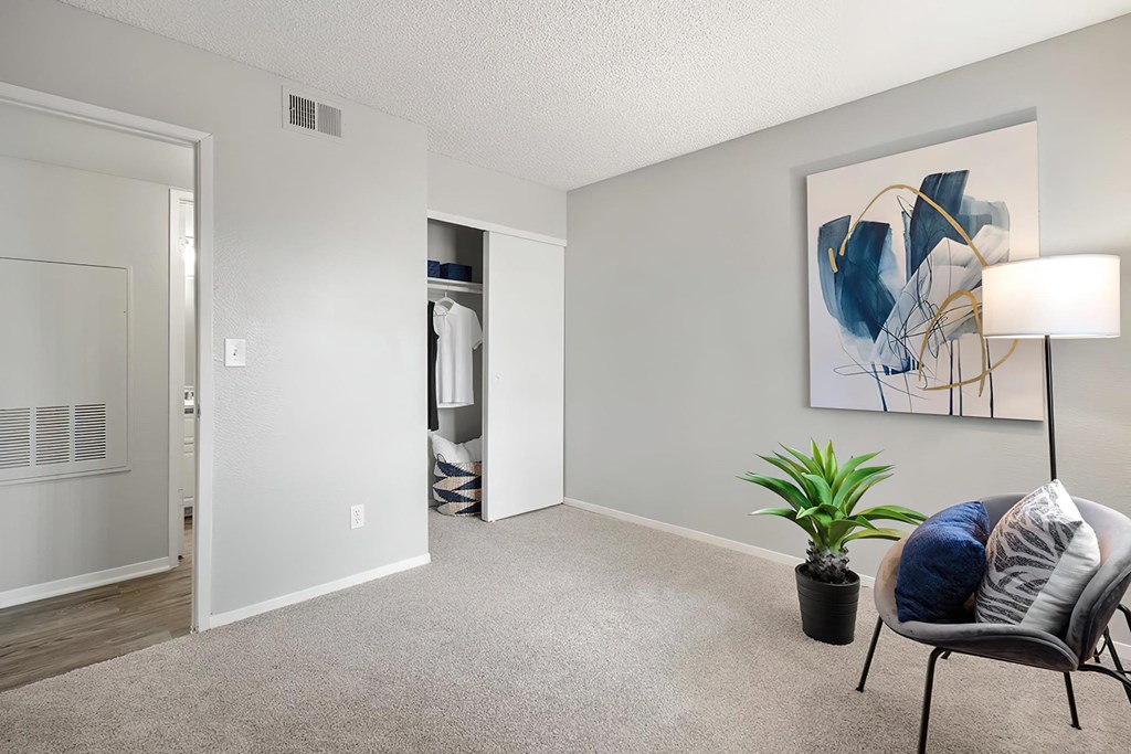a living room with a couch and a chair and a potted plant