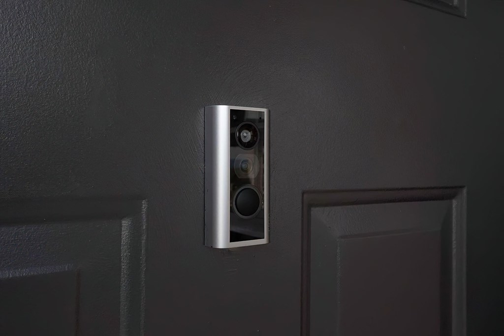 a surround sound speaker on the wall next to a door