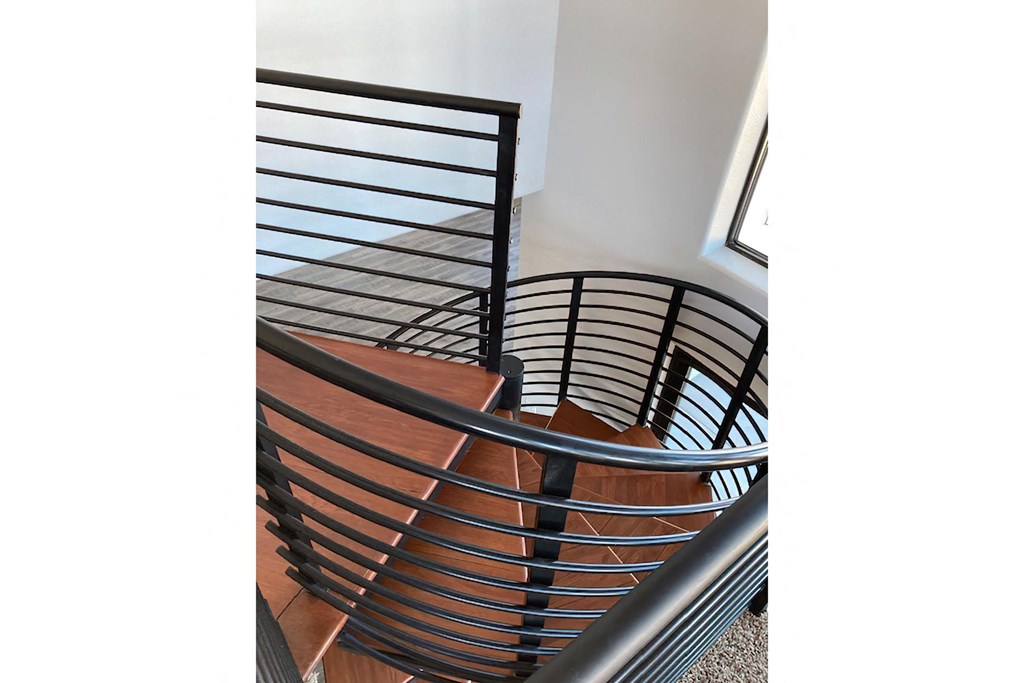 a set of stairs with metal railings in a stairwell