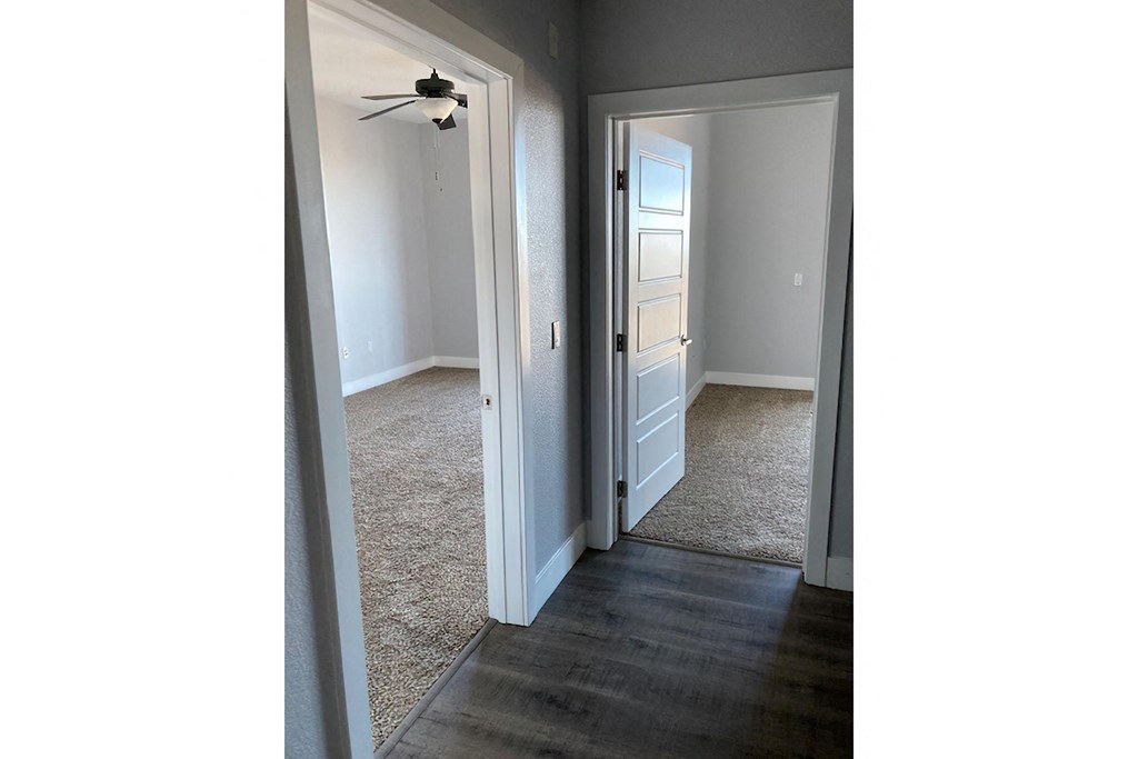a bedroom with a closet and a door open
