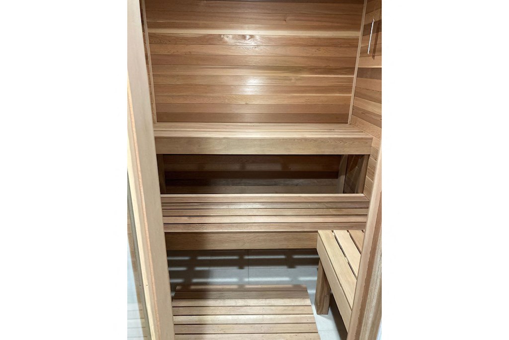 a large closet with wood shelving and wooden floors