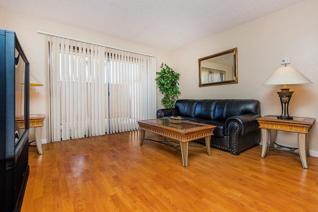 a living room with a leather couch and a table