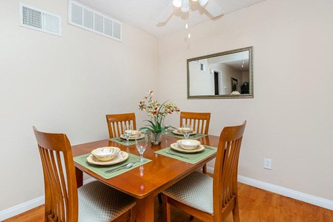 a dining room with a table and chairs