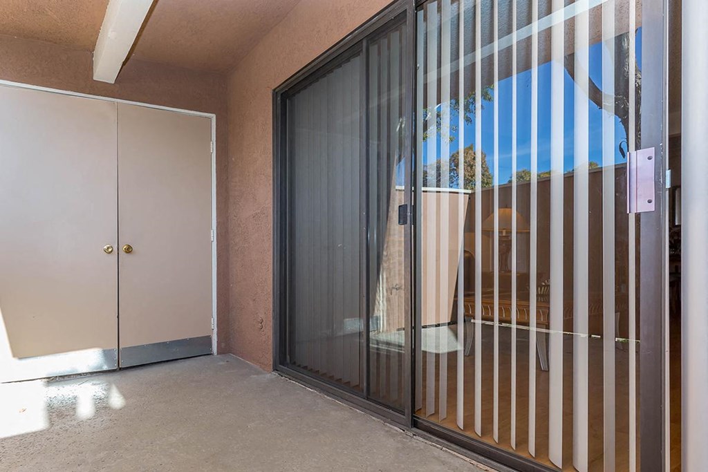 the sliding glass door to the patio of a house