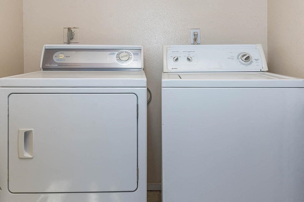 two washing machines next to each other in a room