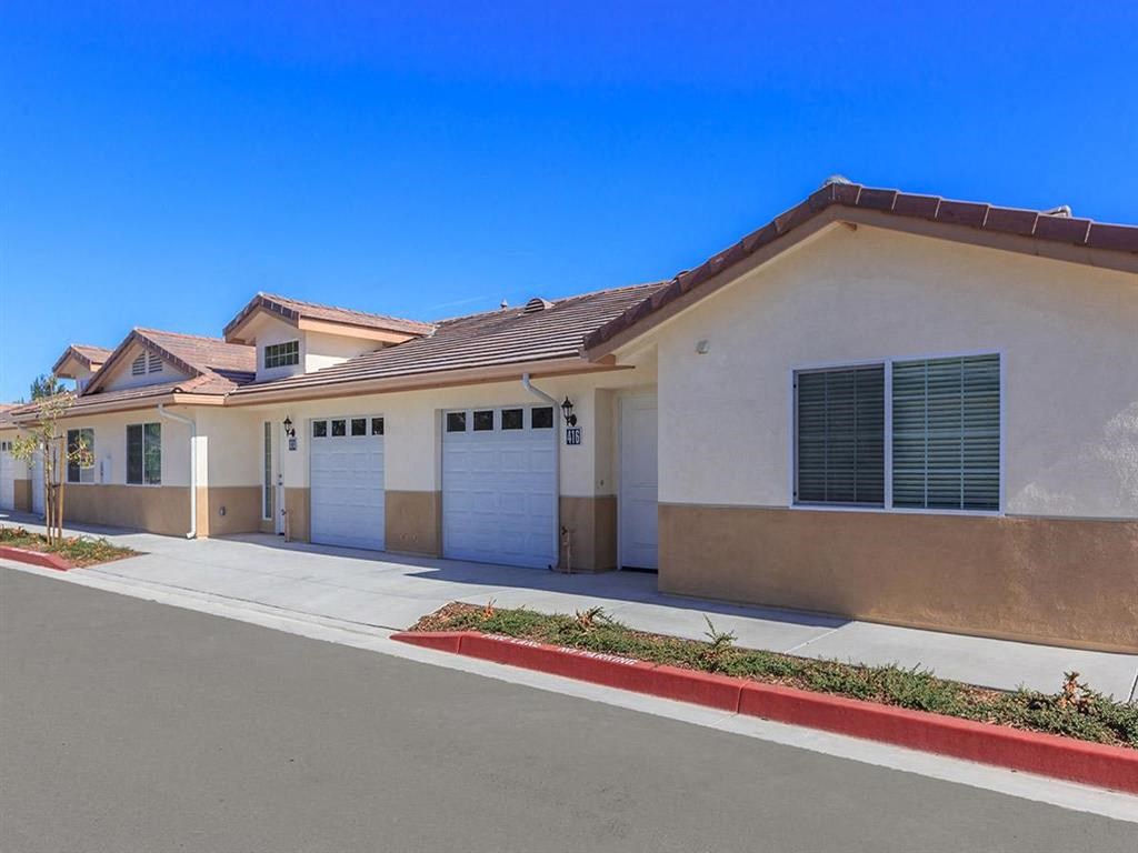 a house with two garage doors and a street in front of it