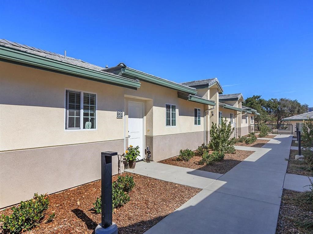 a sidewalk in front of a row of houses