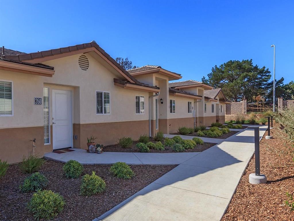a row of townhomes with a sidewalk in front of them
