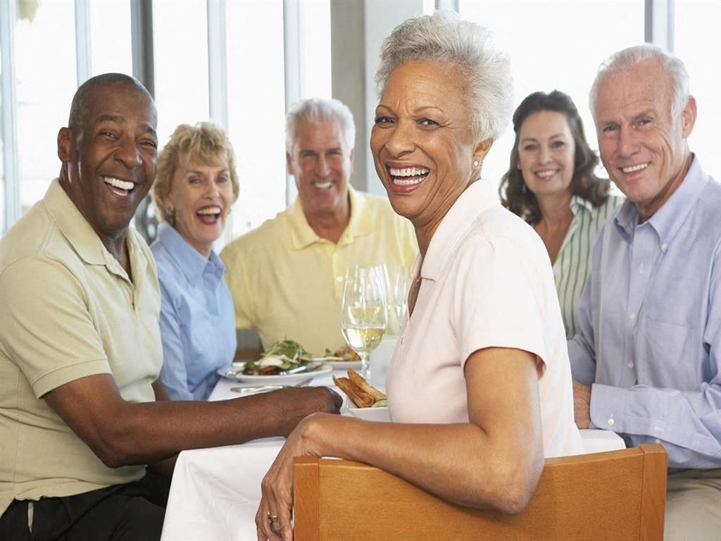 a group of people sitting at a restaurant table