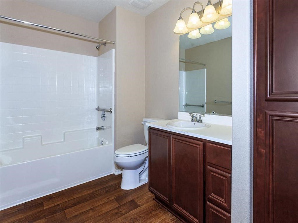 a bathroom with a toilet and a sink and a shower
