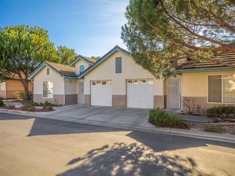 a house with two garage doors and a driveway