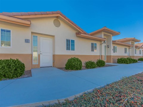 a building with a driveway and a white door