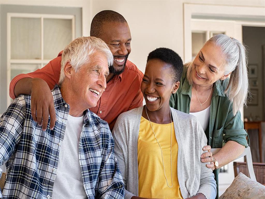 a group of people laughing together in a living room