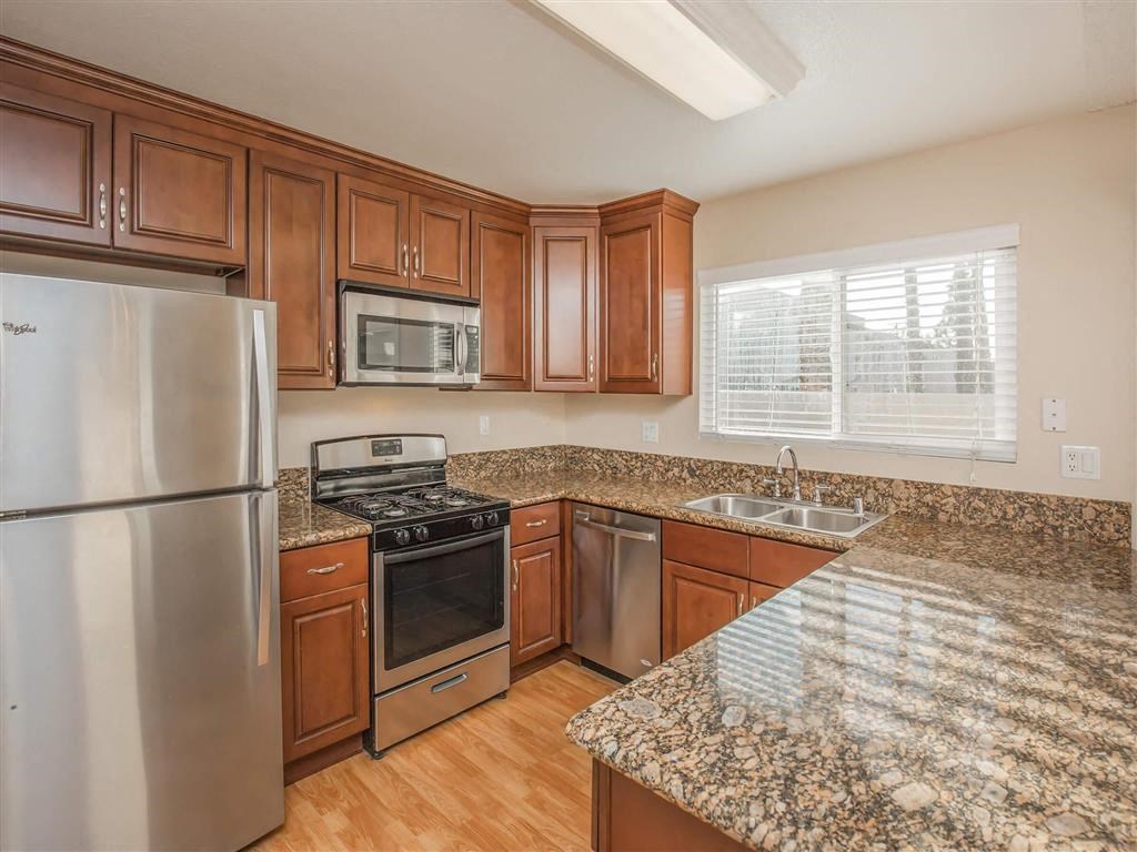 a kitchen with granite counter tops and stainless steel appliances
