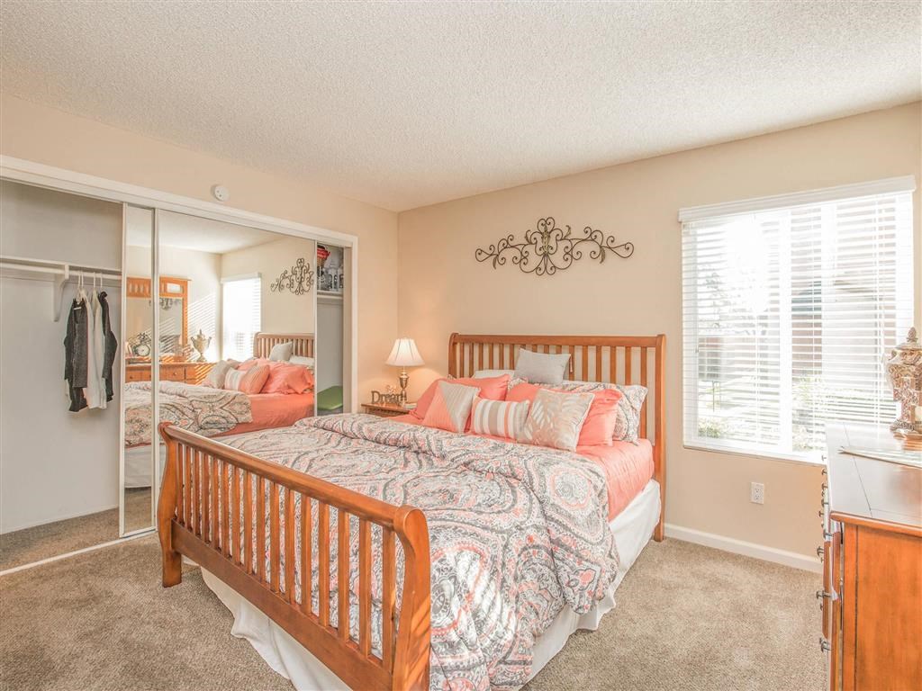 a bedroom with a bed and a closet