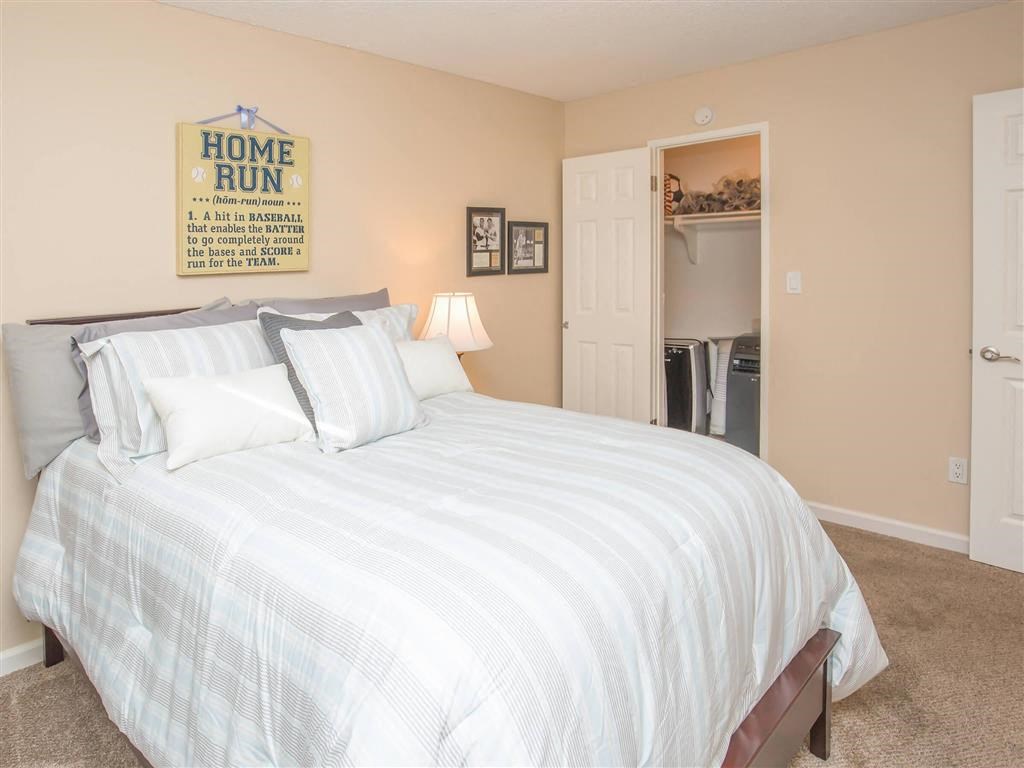 a bedroom with a bed and a door to a bathroom