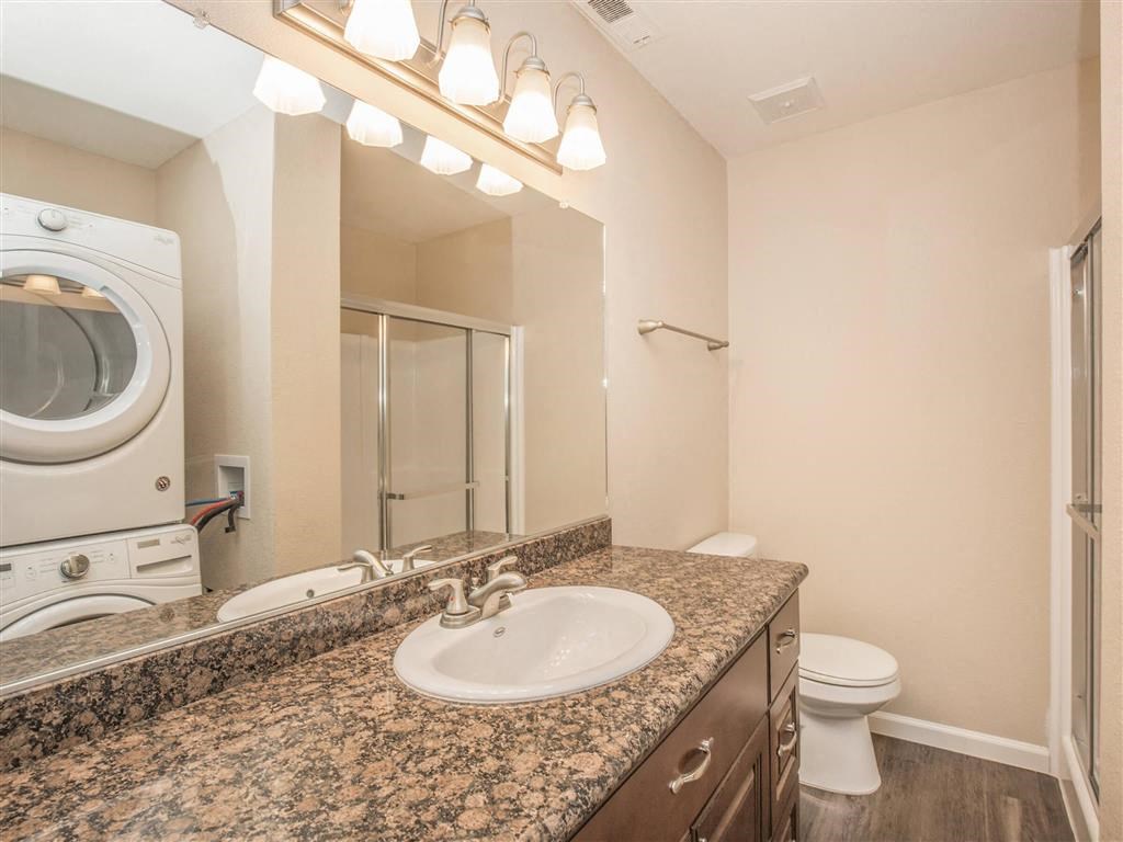 a bathroom with a sink and a toilet and a mirror