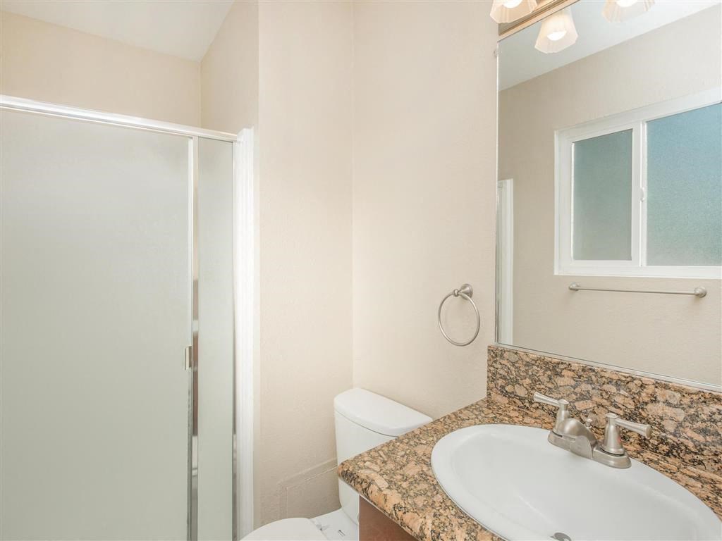 a bathroom with a sink and a toilet and a shower