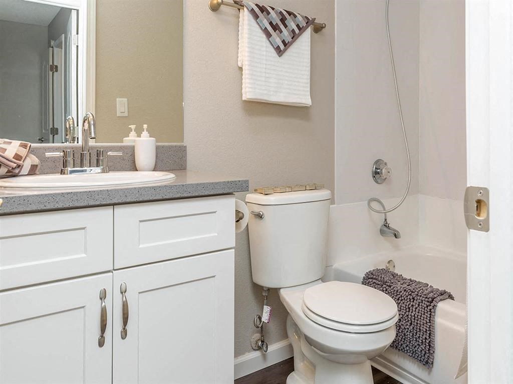 a white bathroom with a toilet and a sink