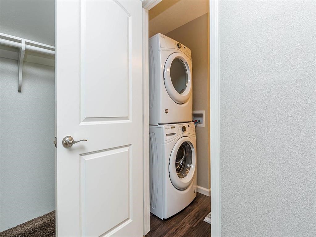 a washer and dryer in a small closet with a door