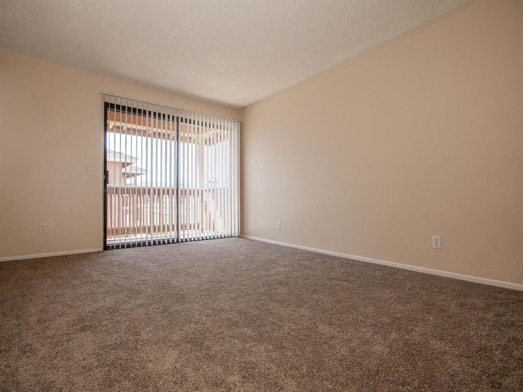an empty living room with a sliding glass door