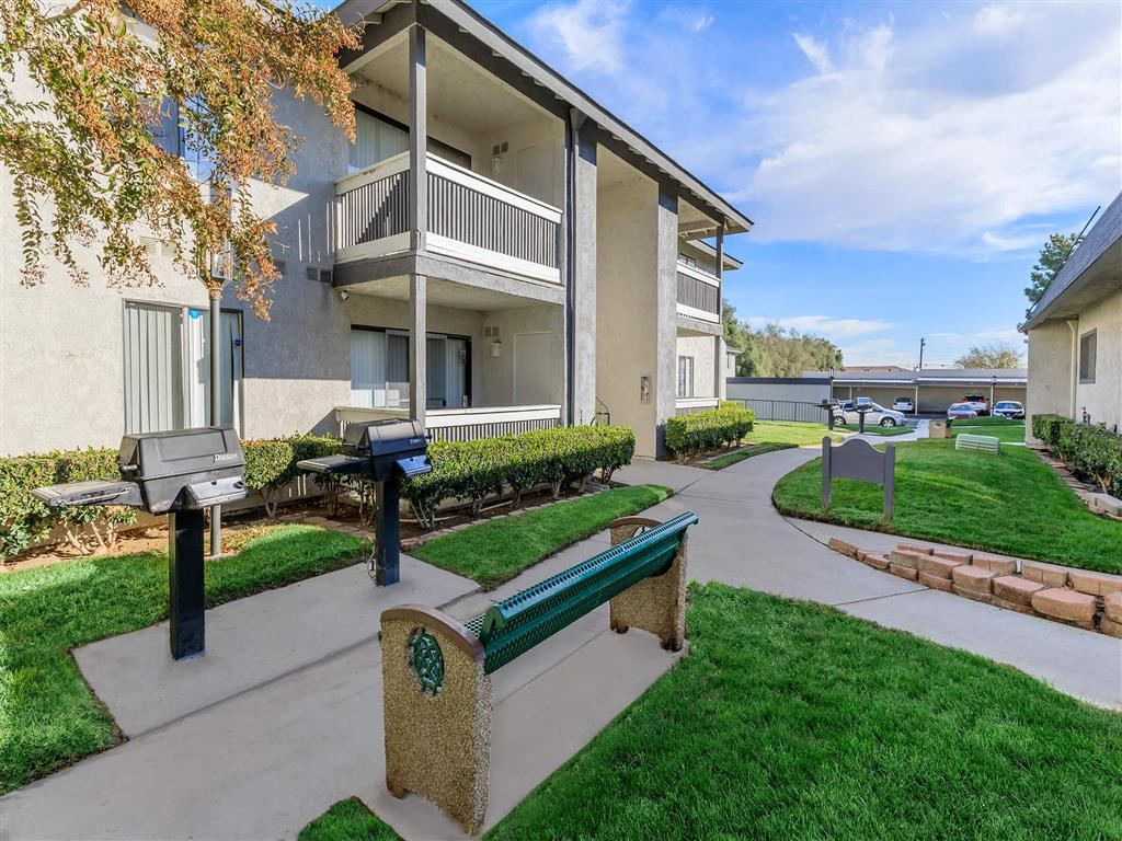 a park bench in front of an apartment building
