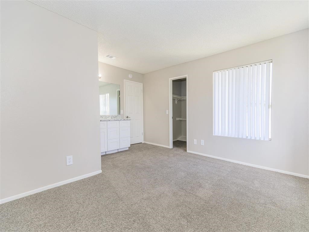 an empty living room with a sink and a window