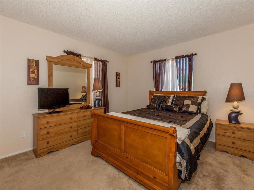 a bedroom with a bed and a tv in it