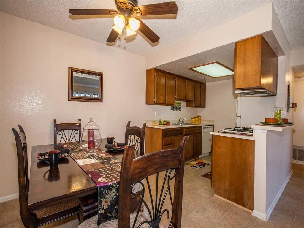 a kitchen and dining room with a table and chairs