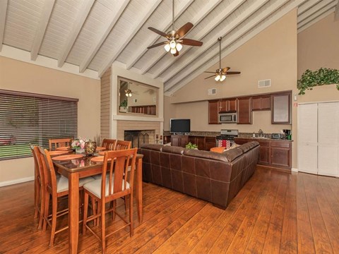 A dining room with a wooden table and chairs.