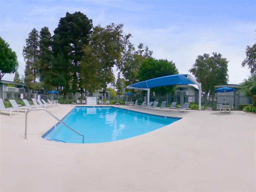 a swimming pool with chairs around it at a resort