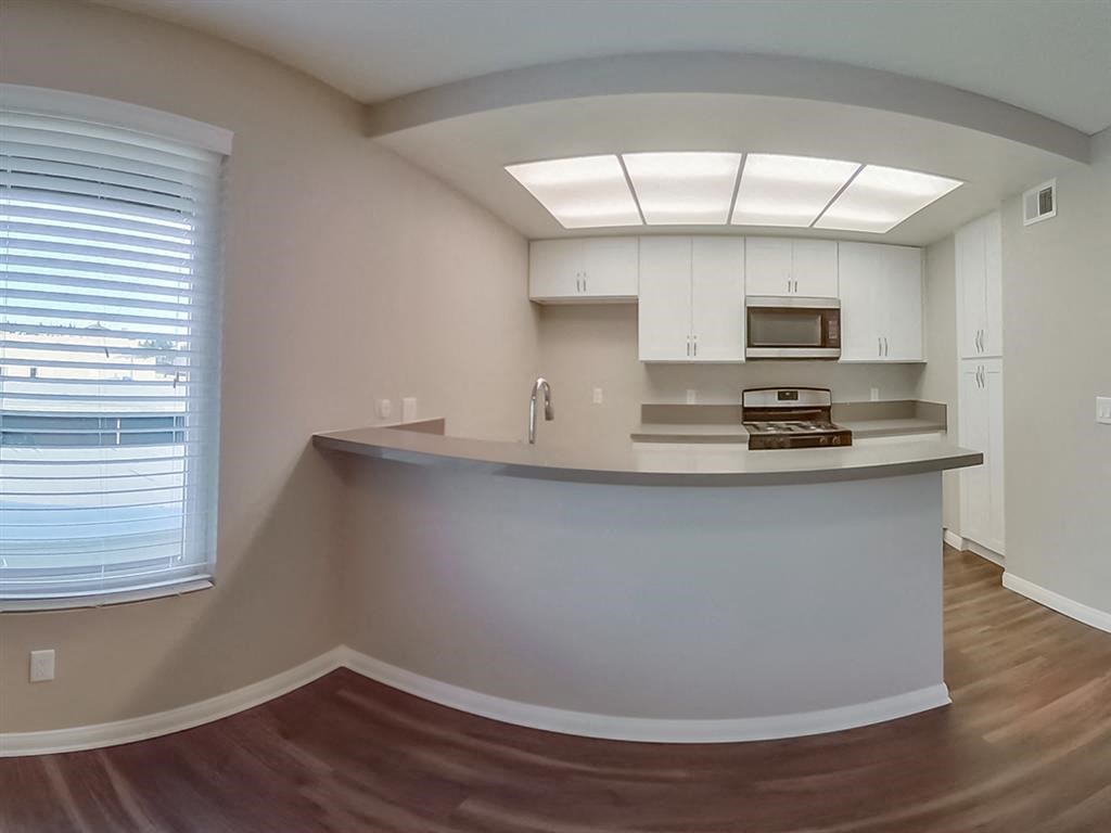 a kitchen with a counter top and a window