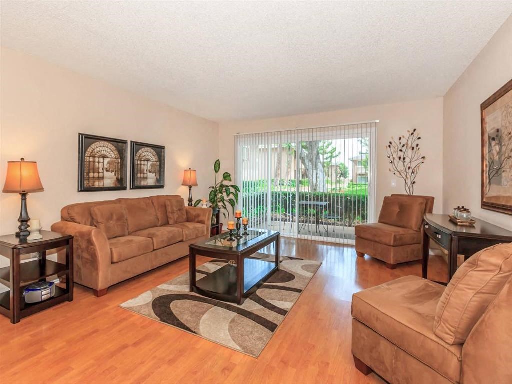 a living room with leather furniture and a sliding glass door