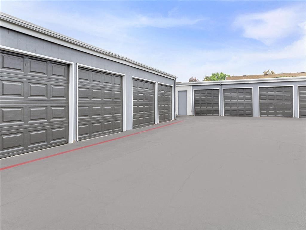 a row of garage doors in a parking lot