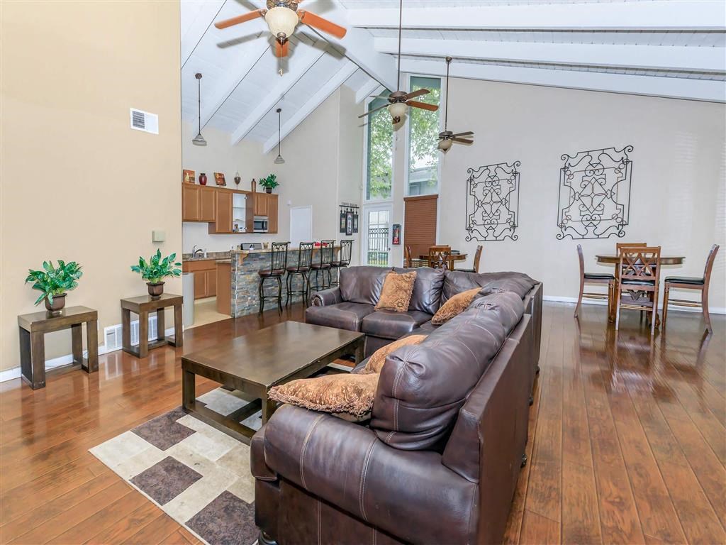 a living room with a leather couch and a table