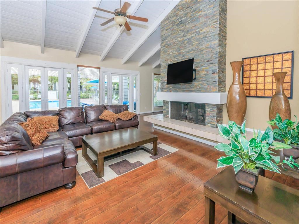 a living room with leather furniture and a fireplace