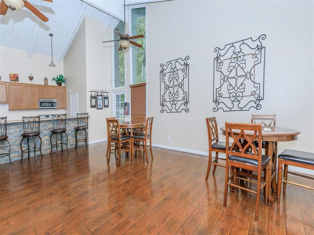 a dining room with a table and chairs and a kitchen