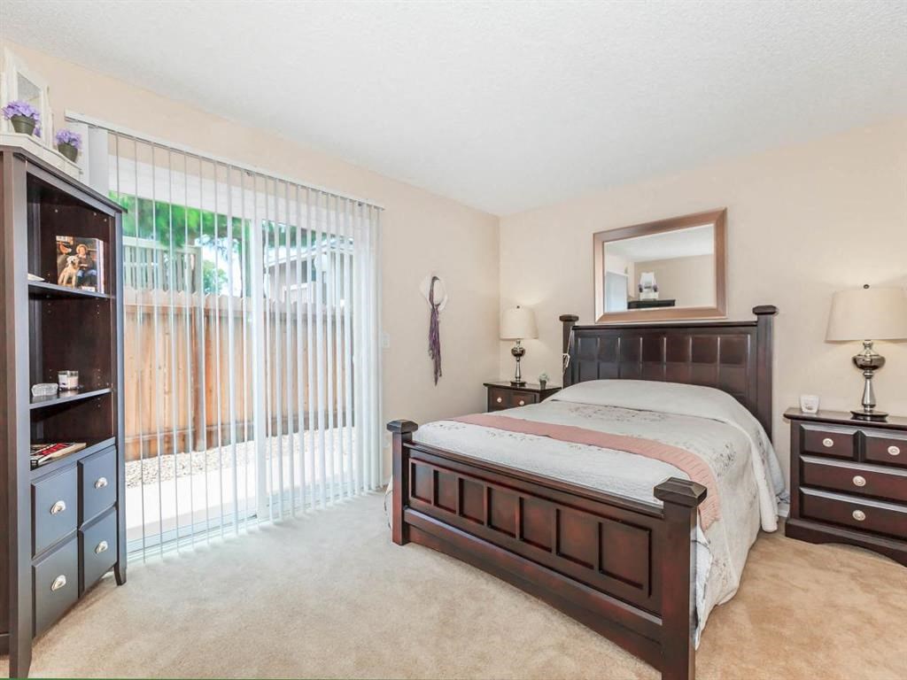 a bedroom with a bed and a sliding glass door